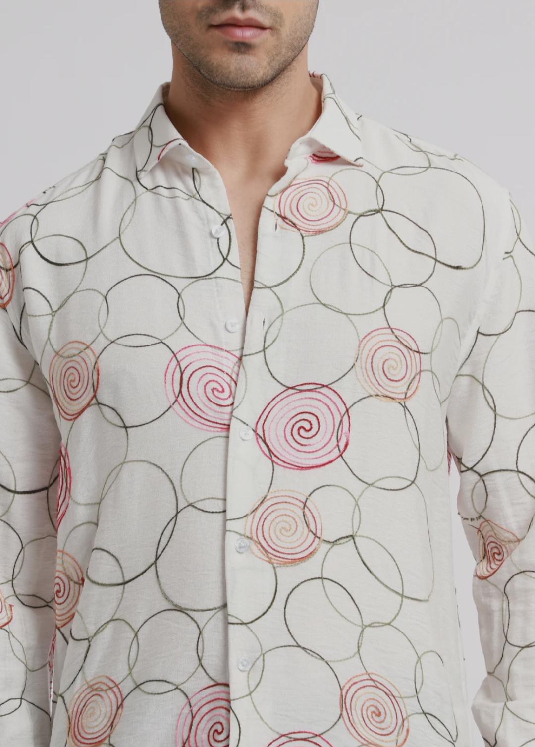 Embroidered white circular shirt.